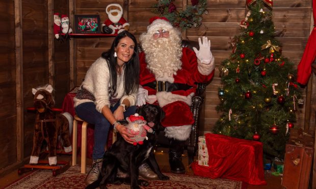 Gayle and her seven-month-old black Labrador puppy Dante meet Santa Paws at Aberdeen's Bon Accord Centre. Image: Kath Flannery/DC Thomson.