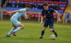 Turriff United's Callan Gray, right, tries to get away from Murray Addison of Keith. Photos by Kath Flannery/DCT Media.