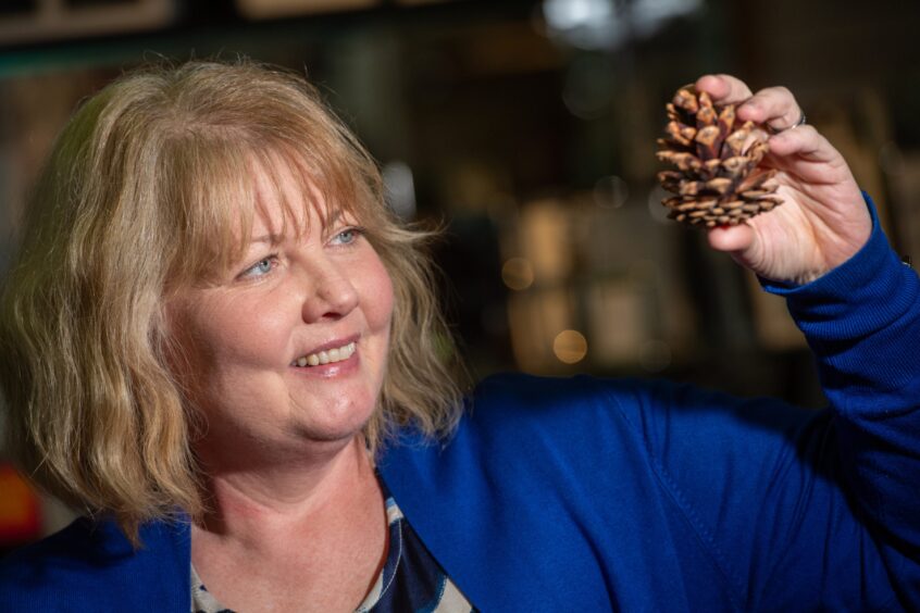 Michelle holding a pine cone