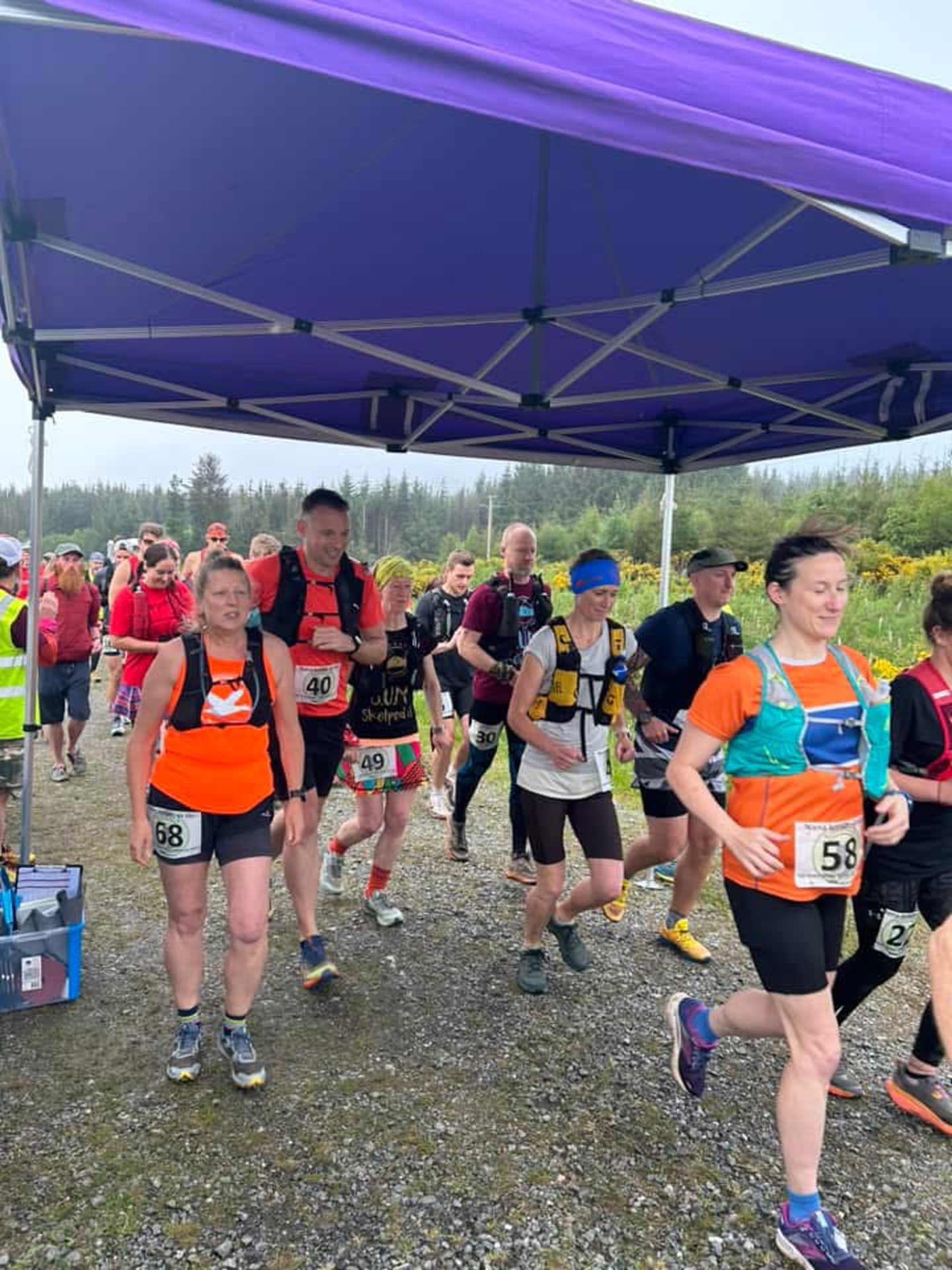 runners under a marquee at the start line of a race