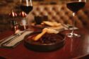 Two glasses of wine around a chutney starter.