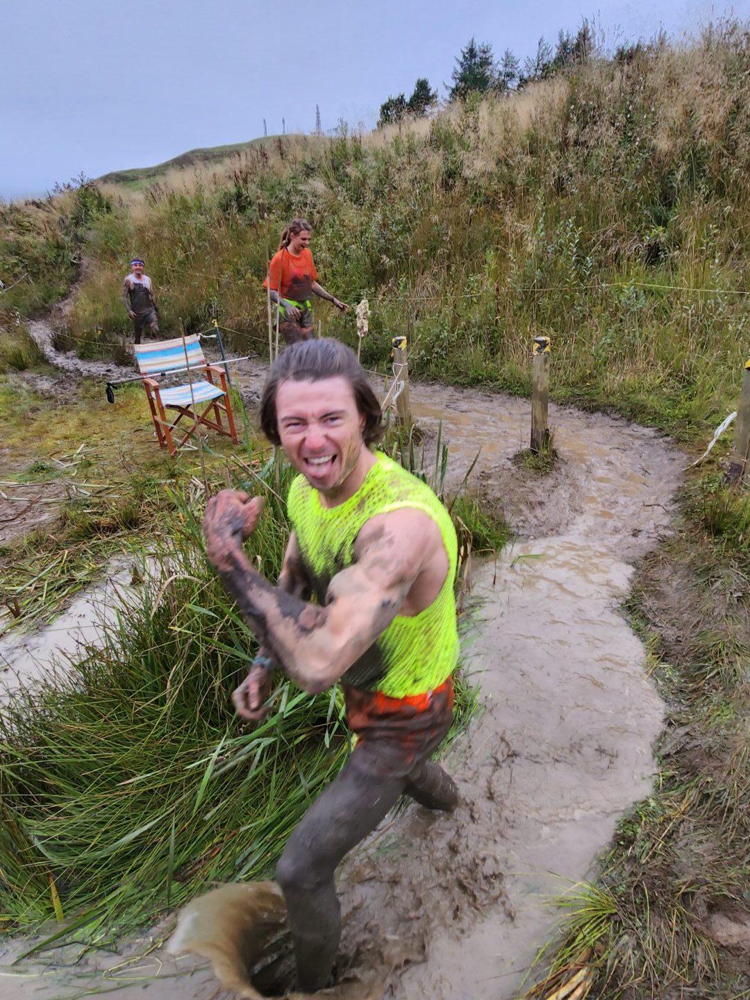 three runners on a muddy path 