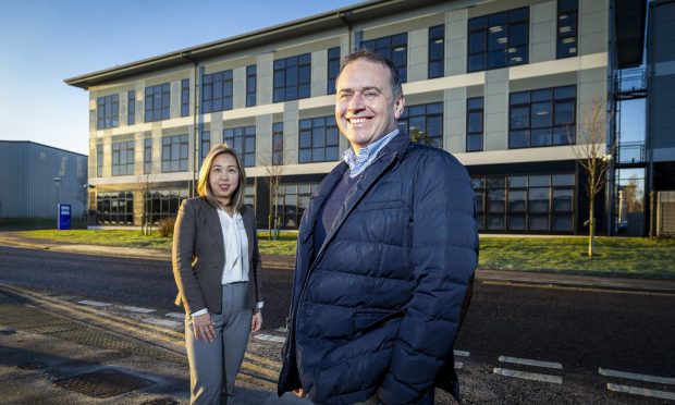 OEG office manager Toto Sanderson and CEO John Heiton outside the firms new HQ in Dyce. Image: Big Partnership