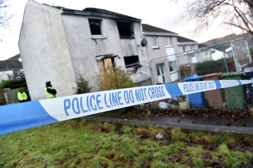 Police tape on Evan Barron Road outside house which went up in flames 