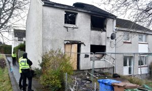 Police officers outside fire damaged Inverness house