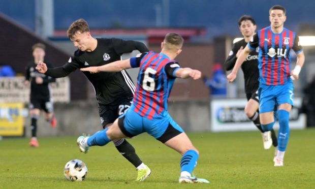 Daniel Devine of Caley Thistle tries to stop an attack from Adam Emslie of Cove Rangers. Image: Sandy McCook/DC Thomson.