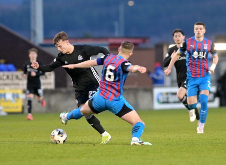 Cove Rangers ace Adam Emslie, who is on loan from Aberdeen, gets the better of Inverness defender Danny Devine during the Aberdeen side's 4-1 League One victory at the Caledonian Stadium, Inverness, on December 28, 2024. 