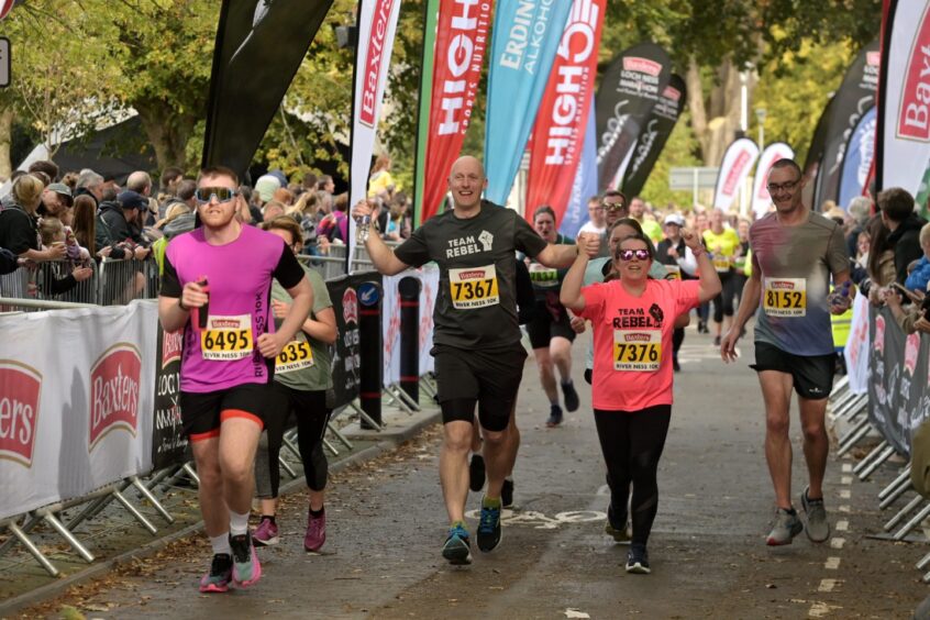 runners cross the finish line at the Baxters Loch Ness Marathon