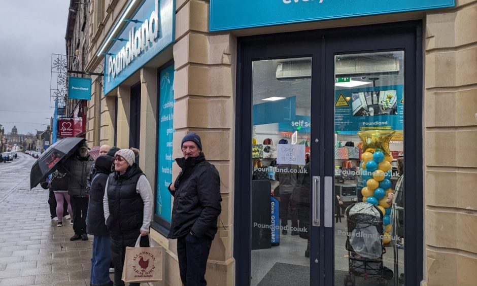 Shoppers queuing outside Elgin Poundland. 