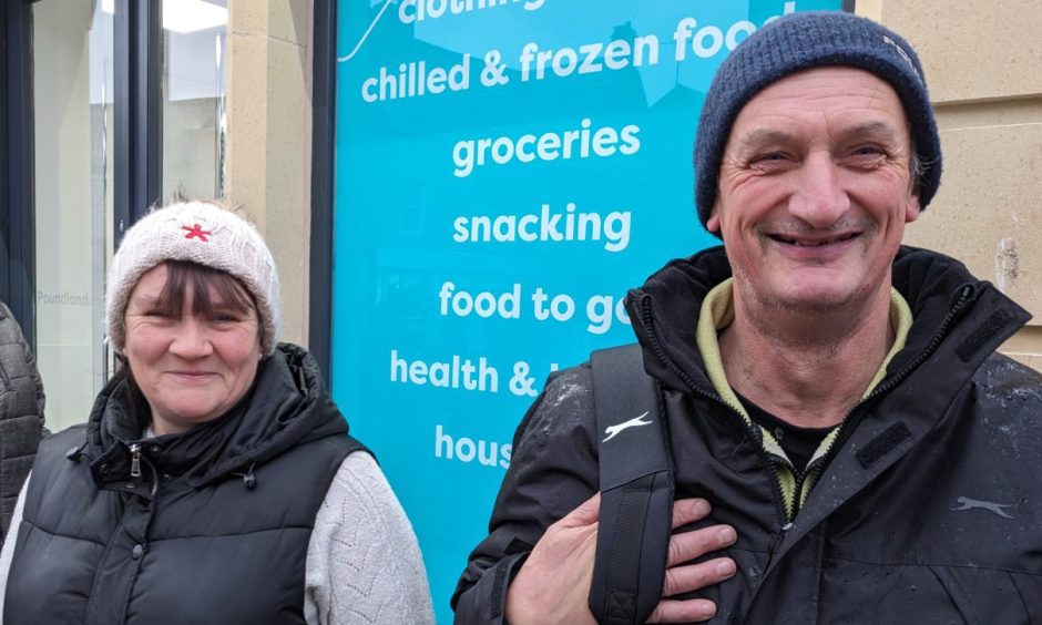 Charlotte and Allan standing outside Poundland. 