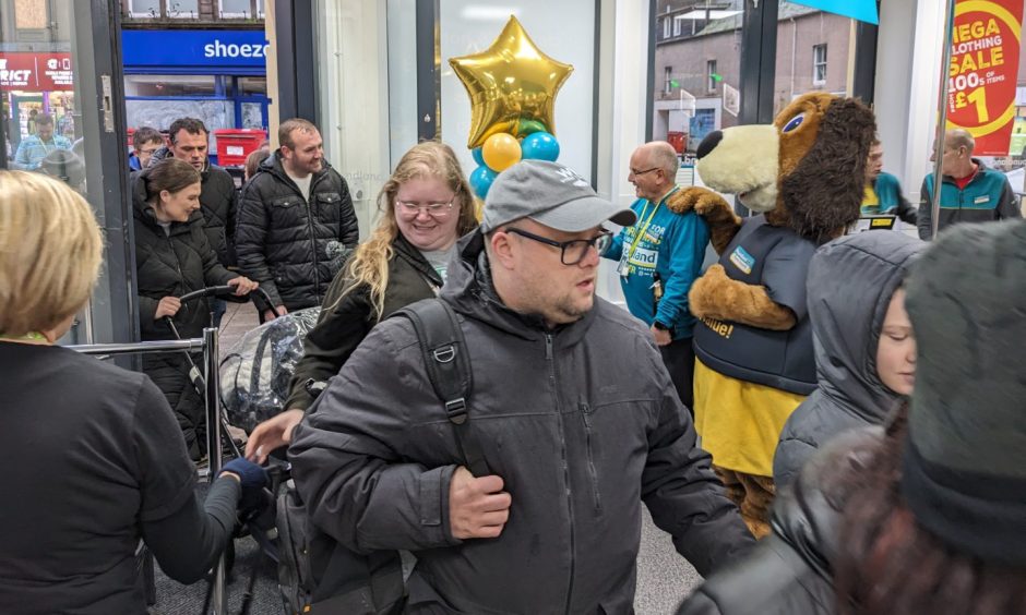 Shoppers entering Elgin Poundland. 