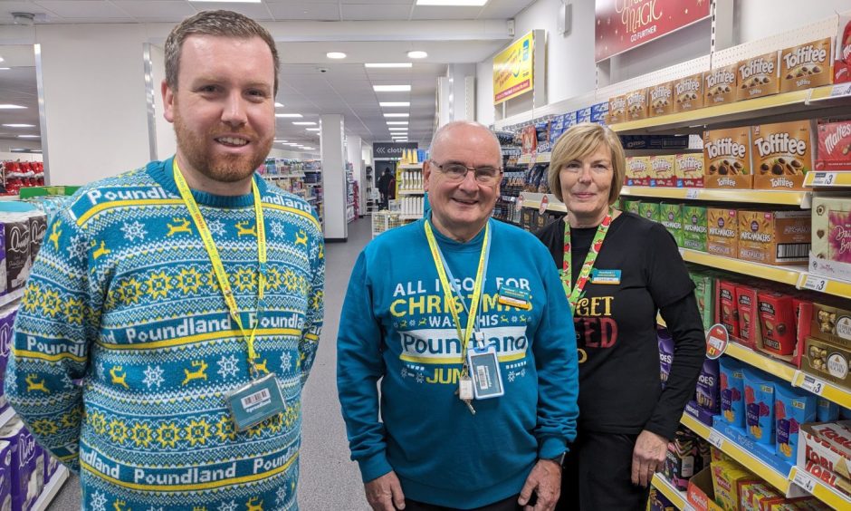 Poundland employees standing inside store. 