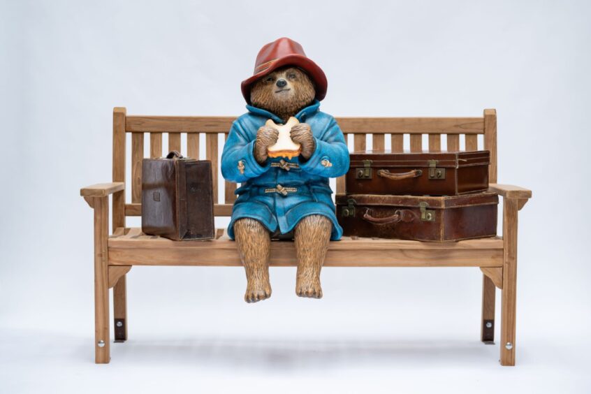 Paddington Bear statue on bench