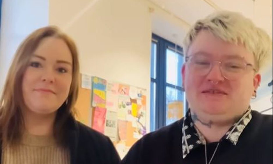 Founders, River Elliott, dressed in black with blonde hair, and Rebecca MacKintosh, dressed in black and brown with light hair, talk to camera within velocity cafe.