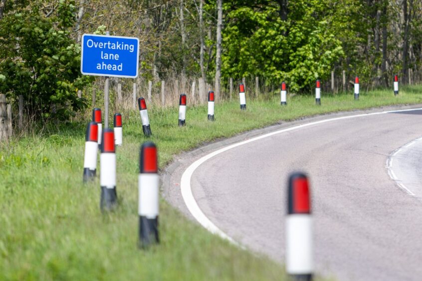 Trees and bushes beside one of the overtaking lane areas on the A96. 