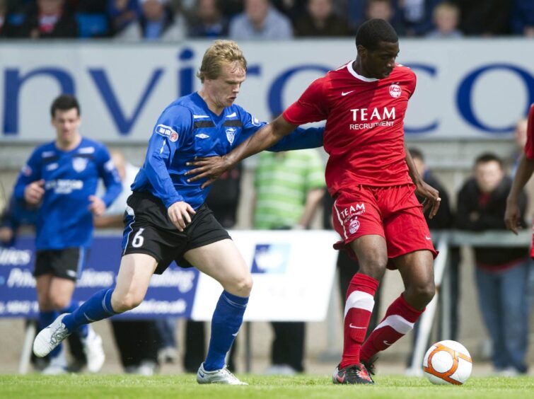 Conor Okus shields the ball in a friendly between Aberdeen and Peterhead.