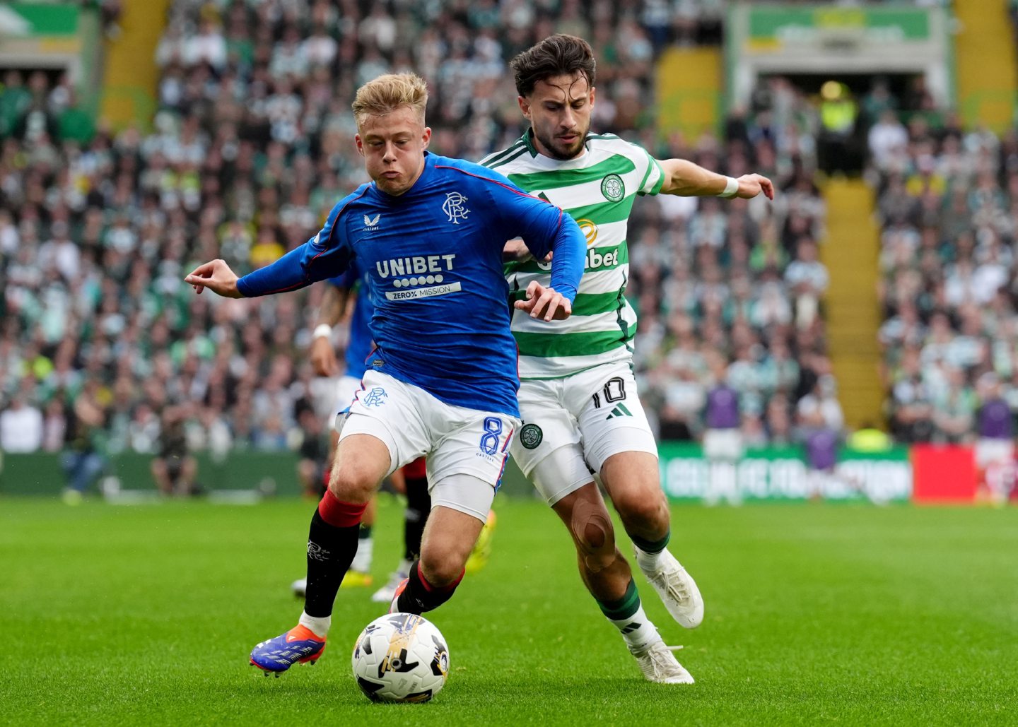 Rangers' midfielder Connor Barron (left) holds off a challenge from Celtic's Nicolas Kuhn in a Premiership match at Parkhead.