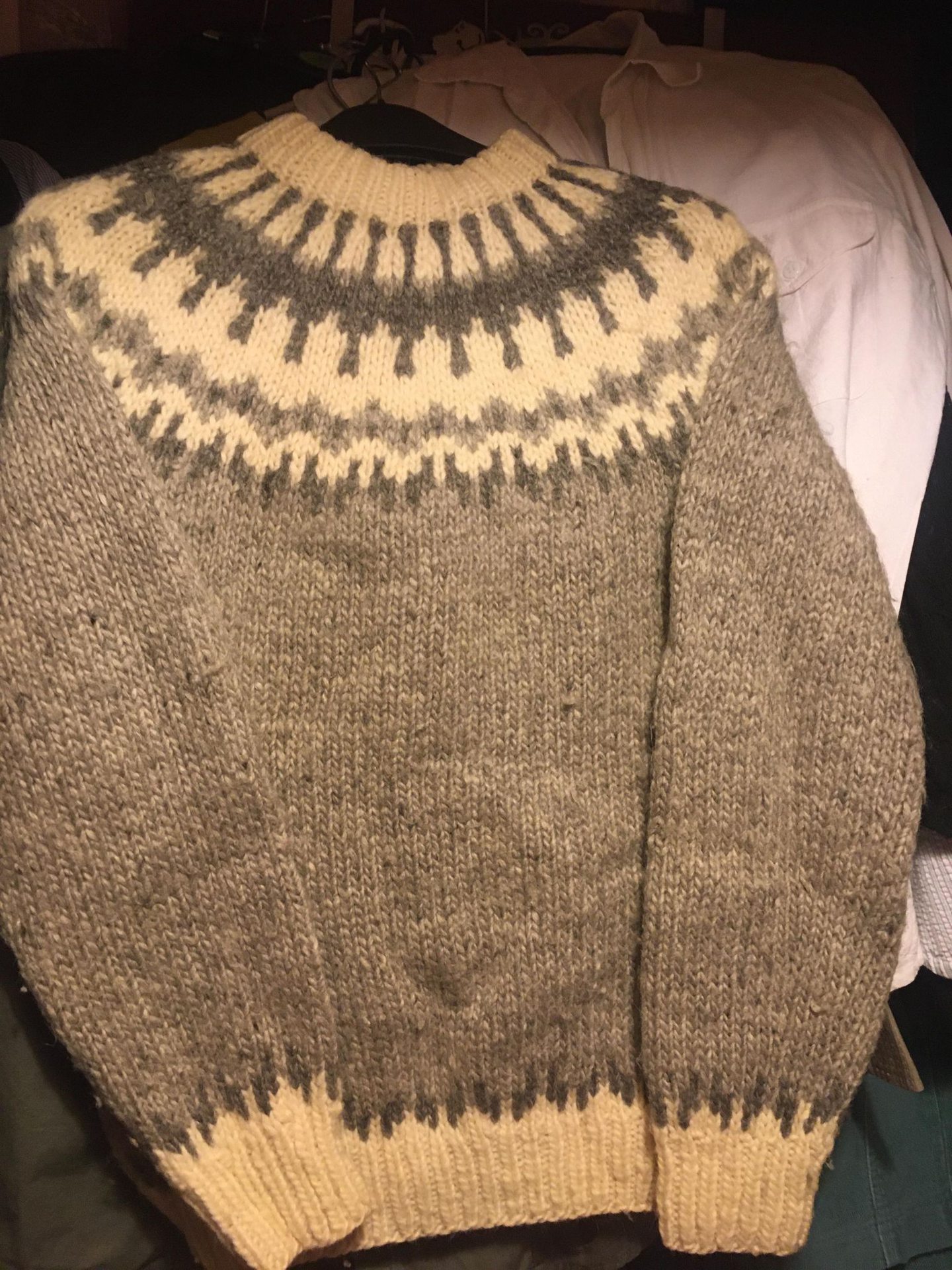 A warm sweater with a patterned yoke in grey and white tones, known as the Sigurd. Thousands were knitted by the Isle of Sanday Knitters.