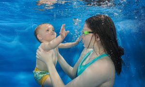 Previously terrified to be under water, Mum Danielle Paterson helps her little boy Teddy during his swim class.