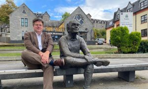 South Lochaber fan Andrew Baxter with the 'sore feet' statue in Fort William at the end of the West Highland Way. Image: Andrew Baxter