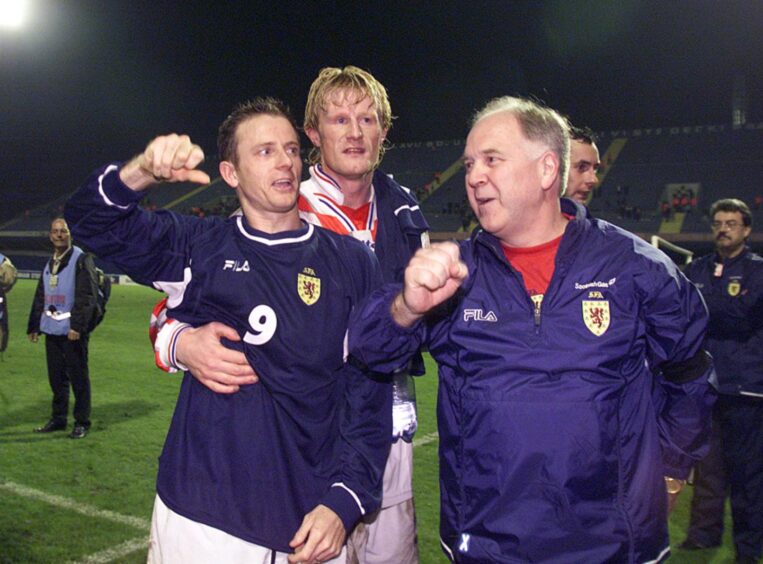 Colin Hendry, centre, with Scotland manager Craig Brown, right, and forward Kevin Gallacher celebrate on the pitch after a 1-1 World Cup qualifying draw in Croatia in October 2000.