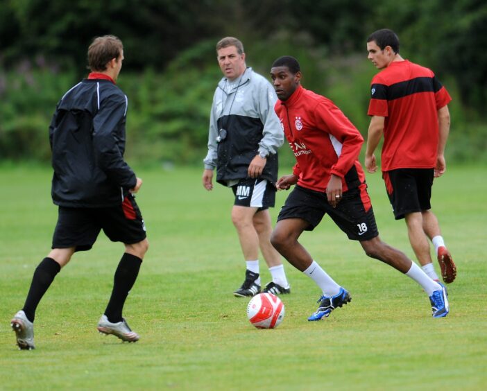 Trialist Craig Rocastle is watched by Aberdeen manager Mark McGhee in a training session in 2009.