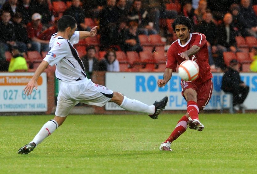 Adnan Ahmed makes a pass in a friendly for Aberdeen at Dunfermline Athletic in 2010.