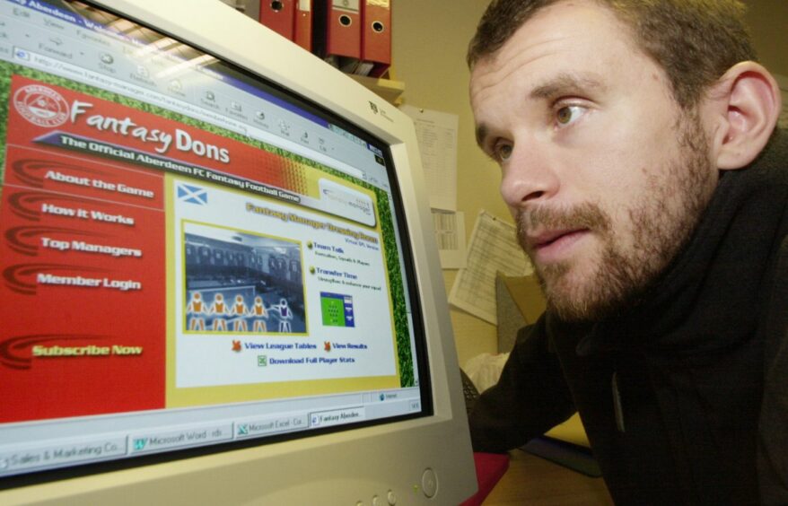 Arild Stavrum is pictured worryingly close to the screen as he tries out a new Aberdeen FC fantasy football computer game.