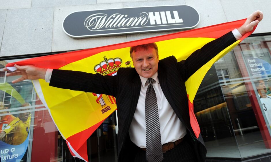 Stewart McKimmie pictured outside a William Hill shop on Union Street when he was backing Spain to win Euro 2008, with a Spain flag across his shoulders