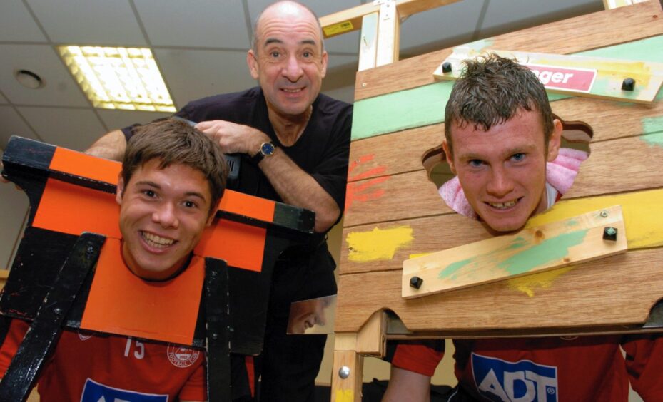 Fifth Dimension magician Bill Duncan looks on as as Jamie Winter and Zander Diamond go under the guillotines.