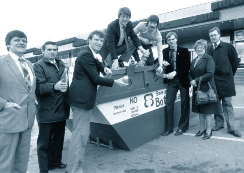 March 1982 saw the launch of bottle banks in Aberdeen with the first being at Fine Fare at Bridge of Dee. At the ceremony were, from left, Fine Fare general manager Gordon Jamieson, Bill Cairns of the cleansing department, Aberdeen players Alex McLeish, Gordon Strachan, Stuart Kennedy (both standing on top of the bottle bank) and Jim Leighton, councillor Margaret Farquhar and director of cleansing David Stephens.