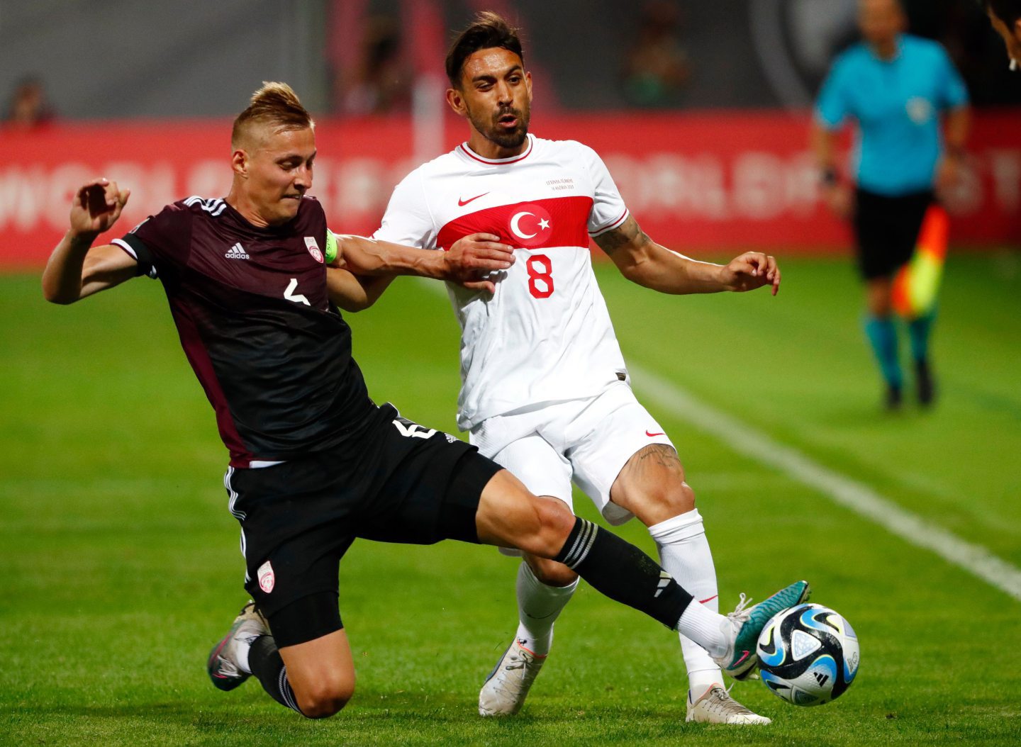 Kristers Tobers (L) of Latvia and Irfan Can Kahveci of Turkey in action during the UEFA EURO 2024 Group D qualifying match in Riga, Latvia, Image: Shutterstock 