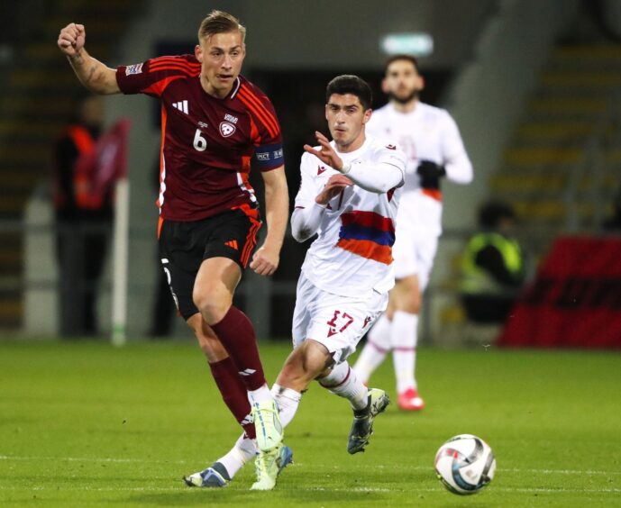 Kristers Tobers of Latvia (L) in action against Grant-Leon Ranos of Armenia during the UEFA Nations League match in November. Image: Shutterstock