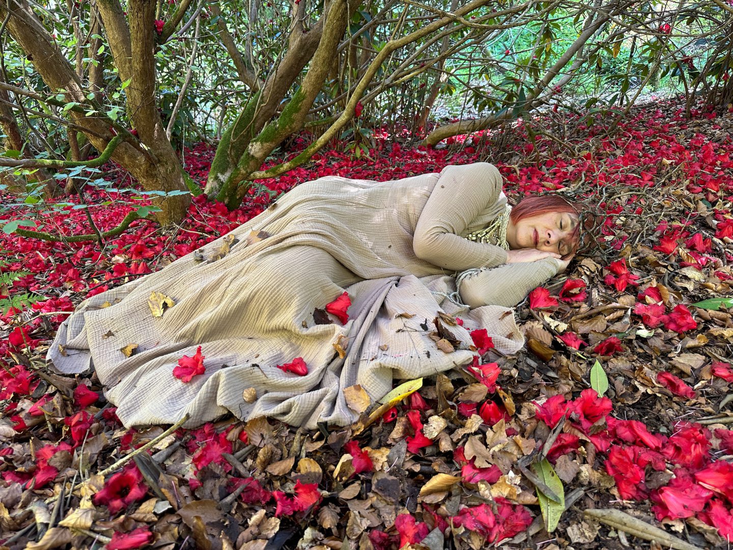 Aberdeenshire musician Fiona Soe Paing pictured lying amongst red flowers at Forglen