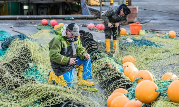 Fishers working on their nets in Peterhead.