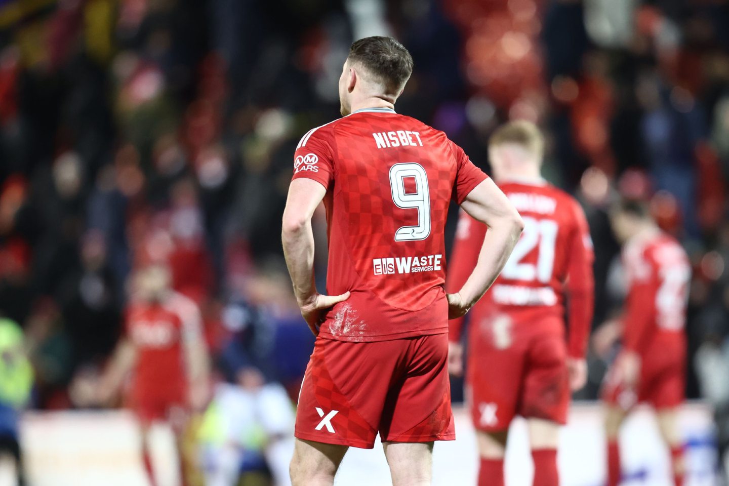 berdeen scorer Kevin Nisbet stands dejectedly at full-time against Ross County. 