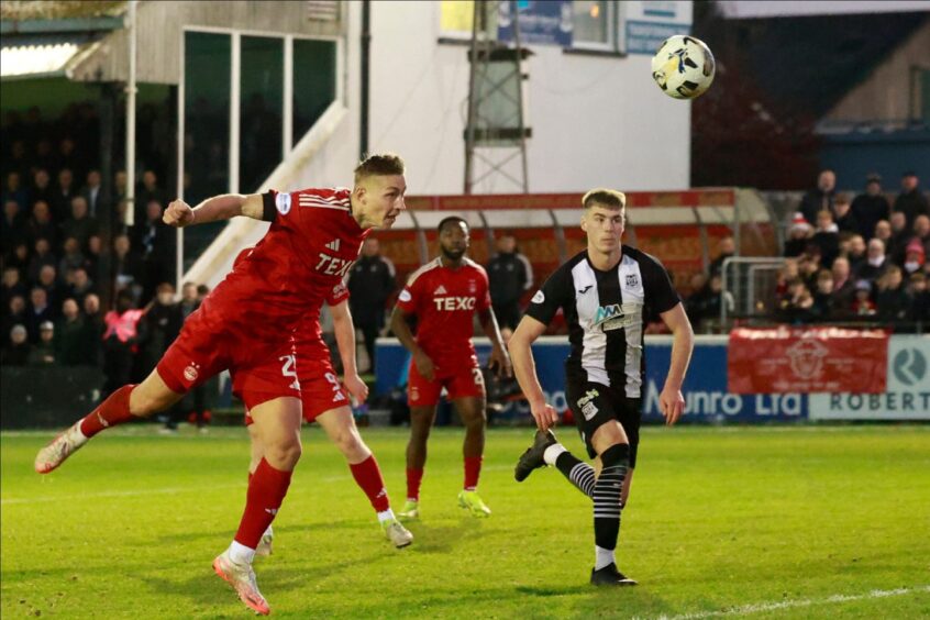 Kristers Tobers of Aberdeen heads at goal during the Scottish Cup fourth round tie against Elgin City. Image: SNS