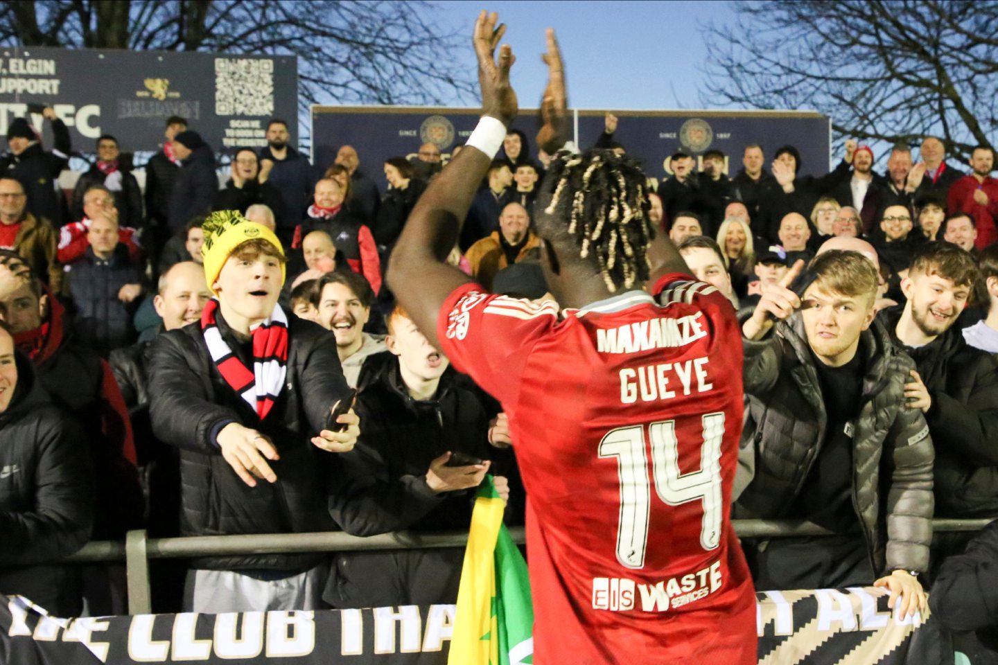 Aberdeen attacker Pape Gueye celebrates with fans after the 3-0 win at Elgin City. Image: Shutterstock