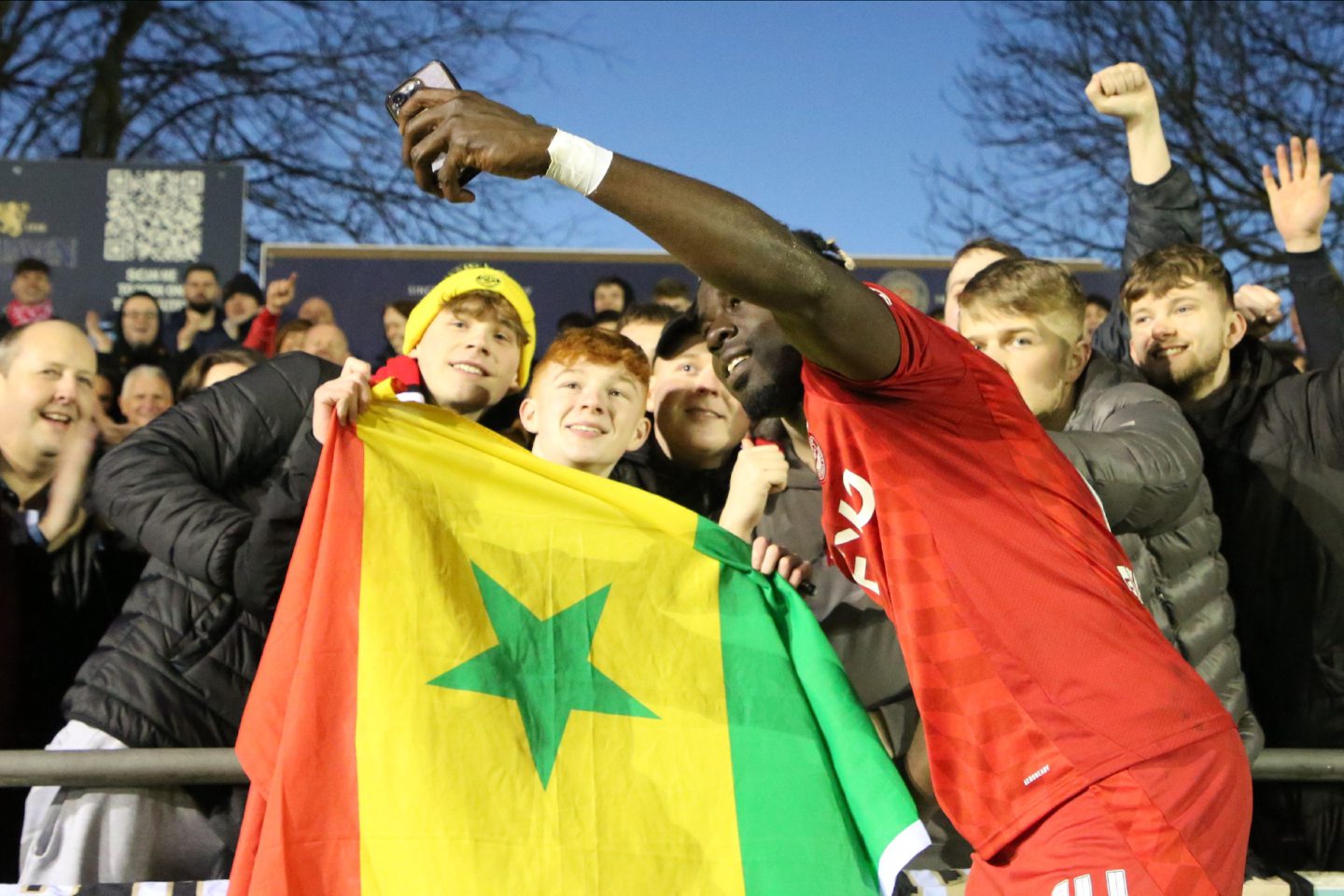 Aberdeen attacker Pape Gueye celebrates with fans after the 3-0 win at Elgin City. Image: Shutterstock 