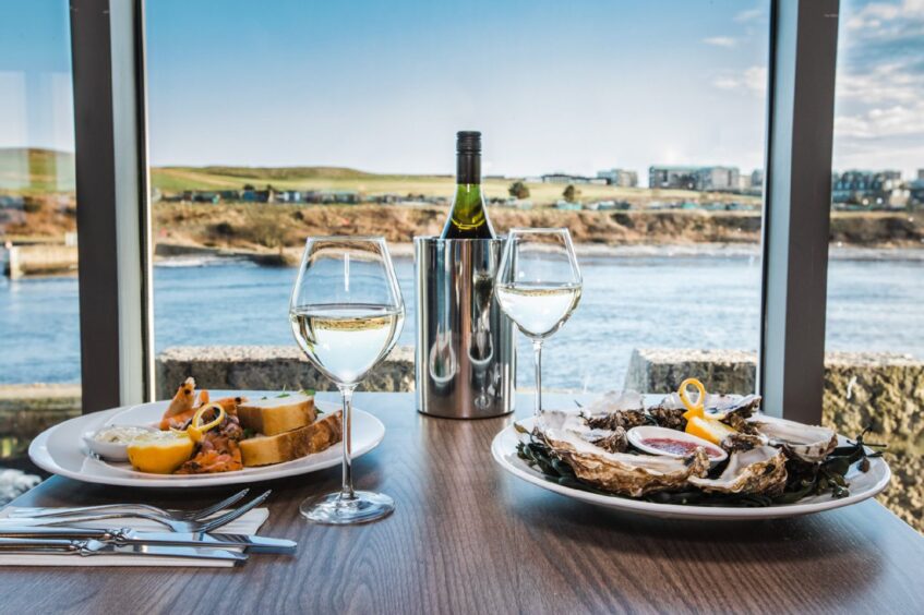 Dinner and wine in a restaurant, with a view of the harbour.