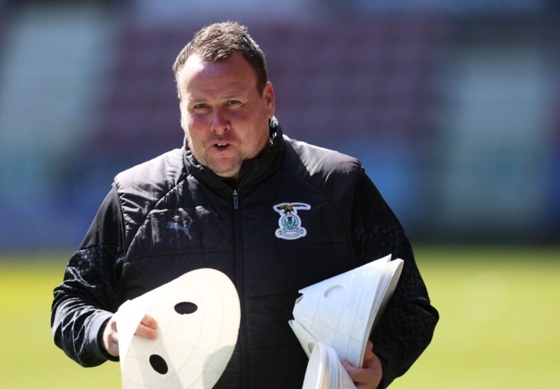 Inverness Caledonian Thistle head coach Scott Kellacher preparing the team's warm-up set-up using cones in his former role as first-team coach for a SPFL Championship match at Dunfermline Athletic's East End Park on April 27, 2024. 