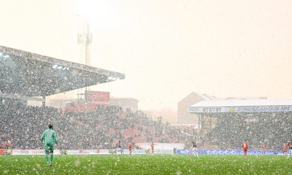 Snow falls during the William Hill Premiership match between Aberdeen and Ross County at Pittodrie, on January 2, 2025. Image: SNS.