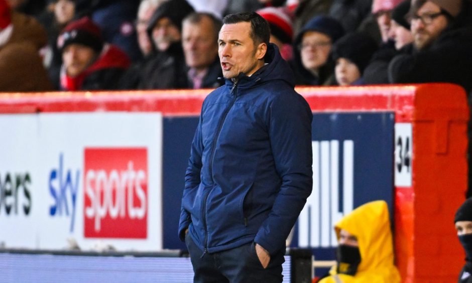 Ross County manager Don Cowie standing on the sidelines with his hands in his pockets