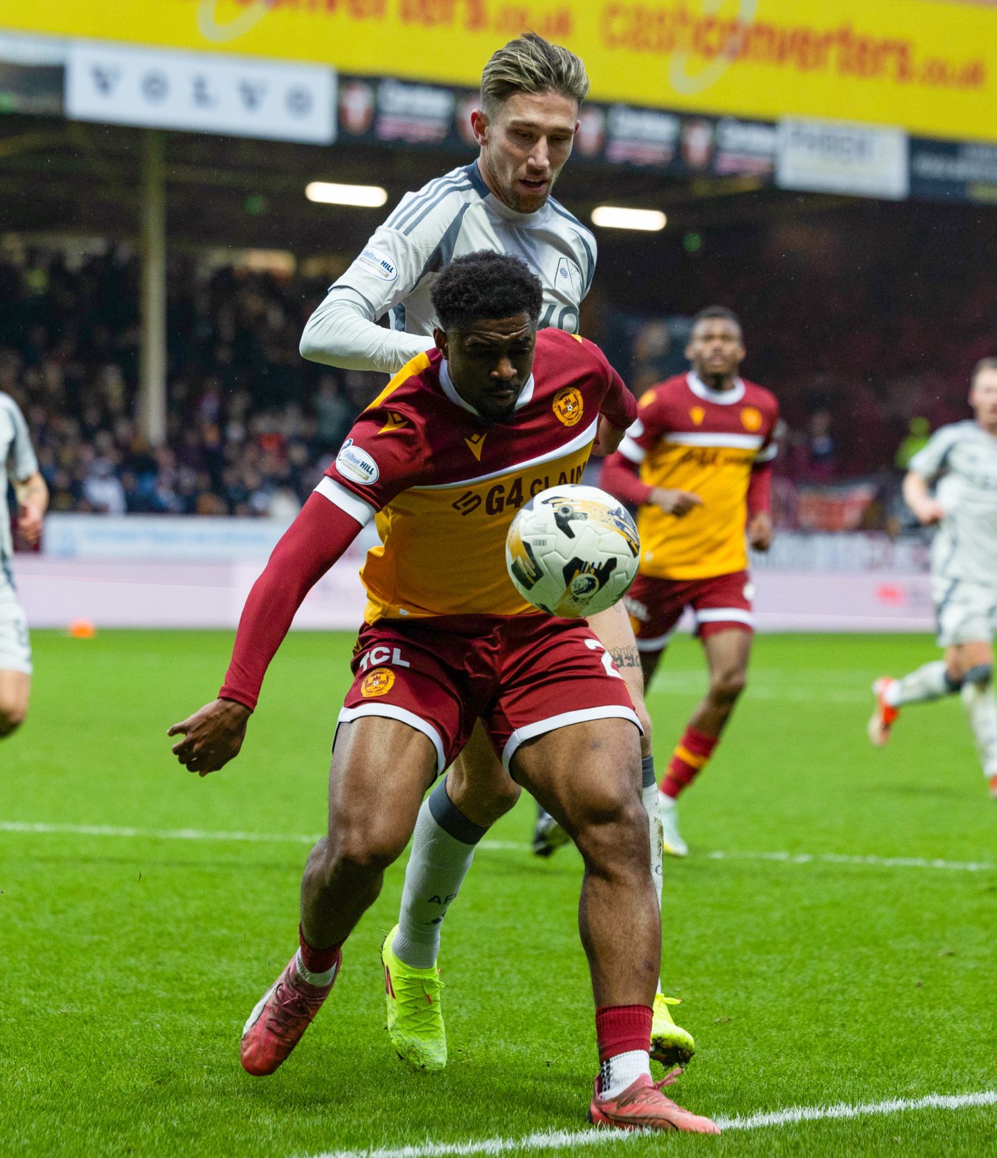 Motherwell's Marvin Kaleta (Front) and Aberdeen's Angus MacDonald in action. Image; SNS