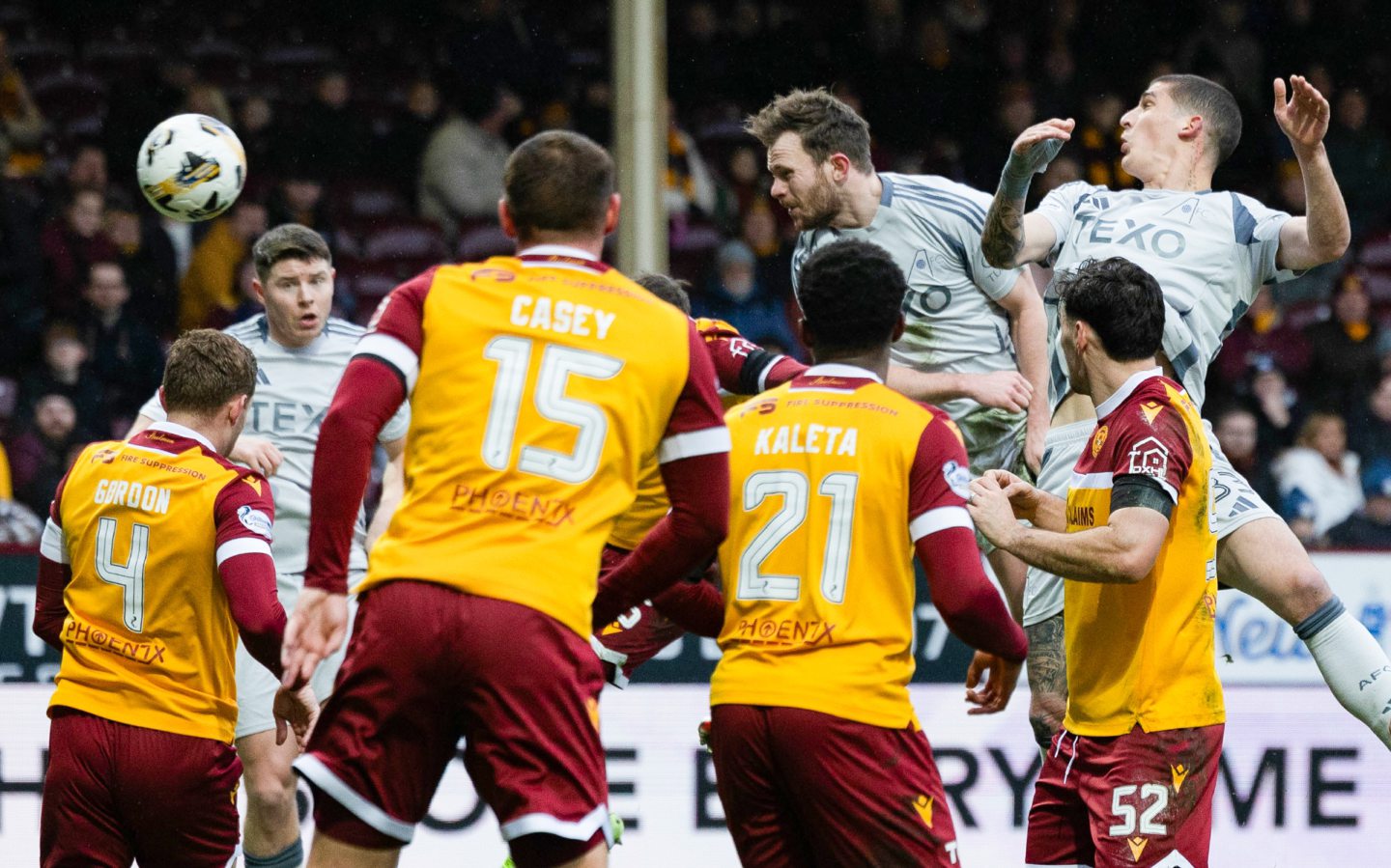 Aberdeen's Nicky Devlin (C) has a headed shot but it's saved by Motherwell's Aston Oxborough. Image; SNS