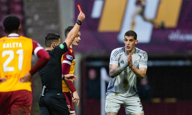 Aberdeen's Slobodan Rubezic is shown a red card by referee Nick Walsh following a confrontation with Motherwell's Tony Watt. Image: SNS.