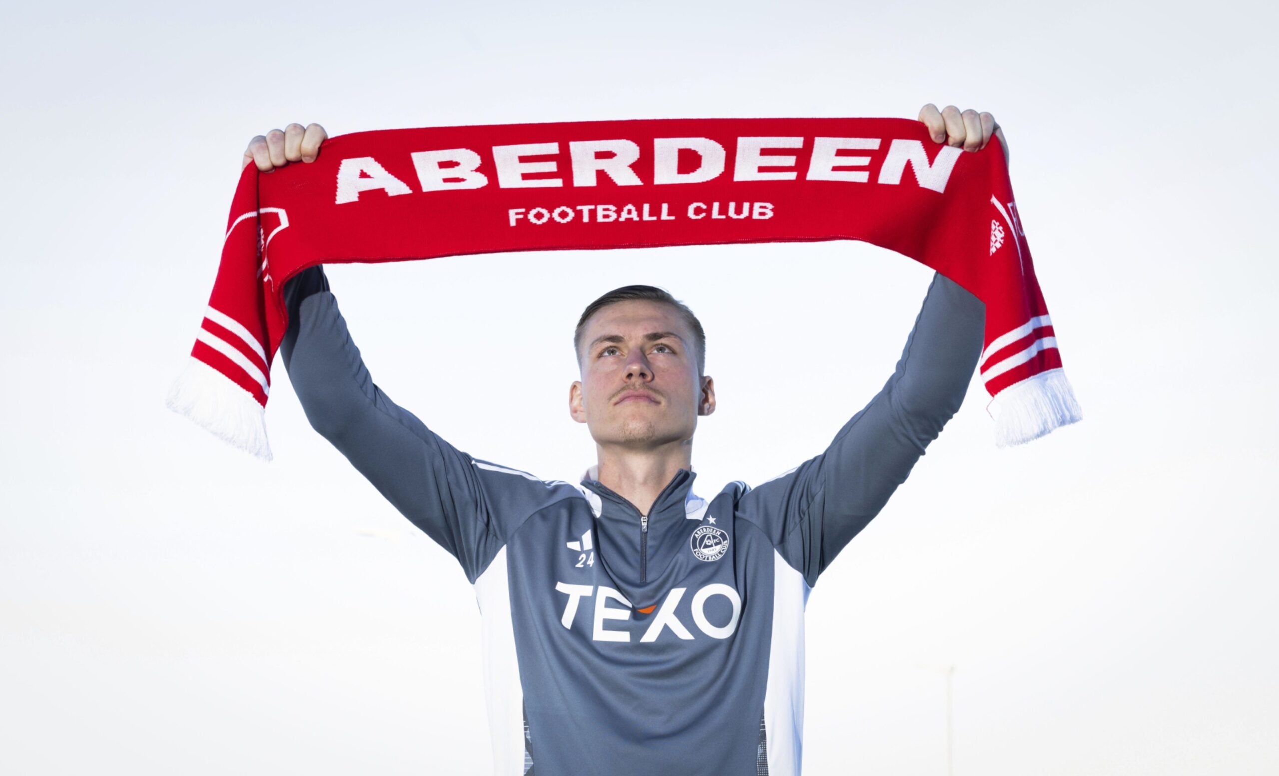 Latvia Captain Kristers Tobers signs for Aberdeen. Image: SNS