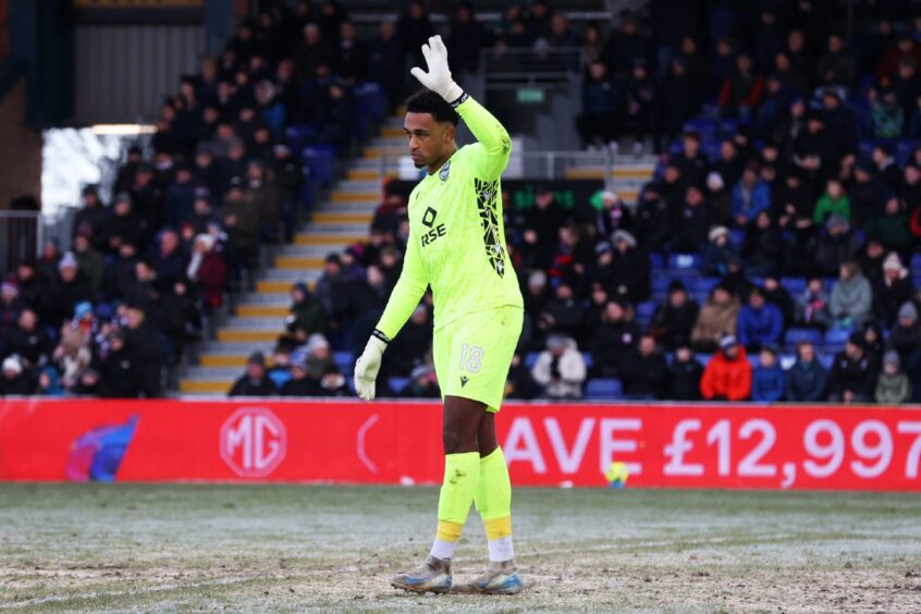 Ross County goalkeeper Jordan Amissah waves to fans as they show support in the 18th minute against Celtic after he received racist abuse on social media this month.