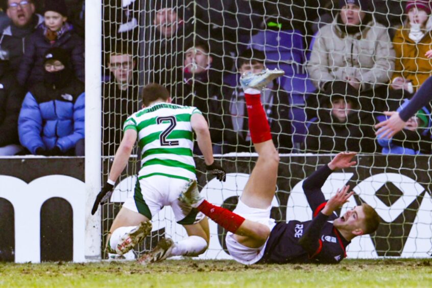 Ross County win a penalty after Kieran Phillips is fouled in the box by Celtic's Alistair Johnston.