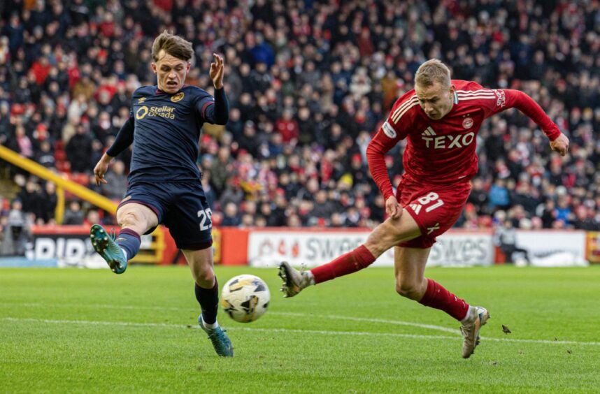 Aberdeen's Topi Keskinen (R) shoots at goal as he is closed down by Hearts' James Penrice . Image: SNS